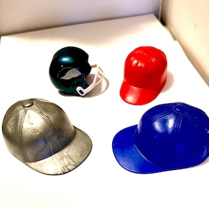 Vintage Pencil Sharpeners Red, Blue and Silver Baseball Hats. Green Philadelphia Eagles Football Helmet.