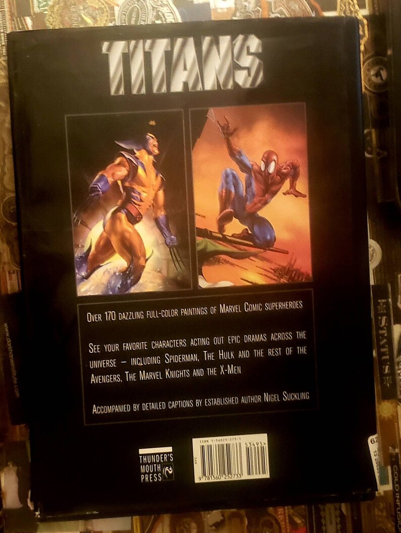 May include: Book cover with the title "TITANS" in large, bold, white letters. The cover features two illustrations: Wolverine in yellow and blue, and Spiderman in red and blue. The back cover text describes the book as containing over 170 full-color paintings of Marvel Comic superheroes.