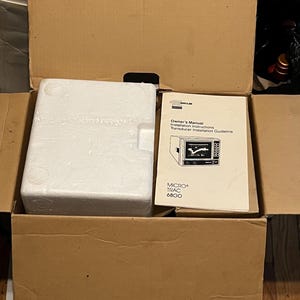 May include: A brown cardboard shipping box containing a white rectangular styrofoam block and a paper manual titled Owner's Manual Installation Instructions Transducer Installation Guideline MICRO TRAC 6800 with a line drawing of the device.