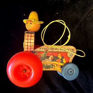 Fisher Price 1960 HAPPY Farmer on Vintage Pull Toy Tractor. Farmer turns head back and forth and wheels wobble when you pull the string.