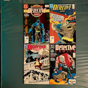 May include: Four comic books featuring Batman. The covers are all different and feature different stories. The top left comic book is titled "Detective Comics" and features Batman in a dark blue suit. The top right comic book is titled "Detective Comics" and features Batman in a dark blue suit fighting a villain. The bottom left comic book is titled "Detective Comics" and features Batman in a dark blue suit fighting a villain. The bottom right comic book is titled "Detective Comics" and features Batman in a dark blue suit fighting a villain.