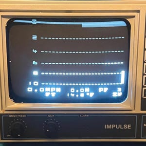 May include: A beige Impulse 680 electronic device with a screen displaying a digital interface featuring horizontal dashed lines numbered 2, 4, 6, 8, and 10. The screen shows text including 0.0 MPH, 0.0M, PF 3, FT, and 14.8 F with control knobs below.