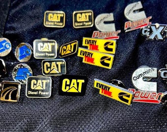 CAT, Cummins, Mack, Peterbilt, International, etc. Trucker and Mechanic Pins! Enamel, Metal, Plastic. Authentic Diesel & Big Engine Pins!