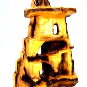 May include: A decorative aquarium ornament resembling a layered rock formation. The structure features a series of arches and openings, with a blend of yellow and brown hues. The design is intended to mimic a natural rock cave.