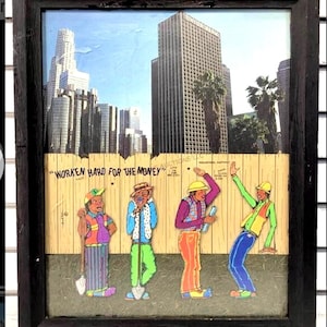 May include: Framed artwork featuring a cartoon depiction of construction workers in front of a cityscape. The artwork includes the text "WORKEN HARD FOR THE MONEY". The workers are colorfully dressed and posed with tools.