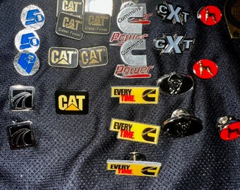 CAT, Cummins, Mack, Peterbilt, International, etc. Trucker and Mechanic Pins! Enamel, Metal, Plastic. Authentic Diesel & Big Engine Pins!