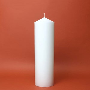 May include: A white pillar candle with a single wick.