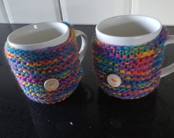 set of two hand knitted chunky rainbow mug cosy with detail wooden button  Great little gift idea for  Birthdays or a treat for yourself