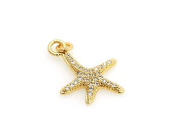 May include: Gold-tone starfish charm with clear crystal accents. The charm has a loop at the top for attaching to a necklace or bracelet.