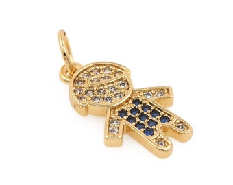 May include: Gold charm pendant in the shape of a person with clear and blue crystals.