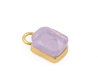May include: A gold charm with a light purple gemstone in a rectangular shape.