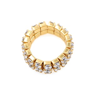 May include: A gold ring with a double row of clear rhinestones.