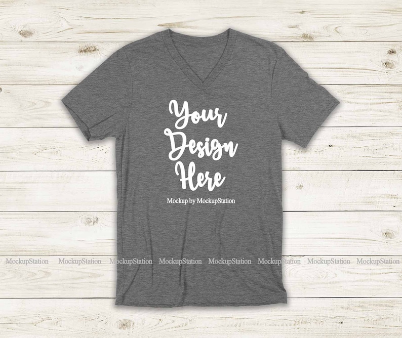 May include: A heather gray V-neck t-shirt mockup with the text "Your Design Here" and "Mockup by MockupStation" printed on the front.