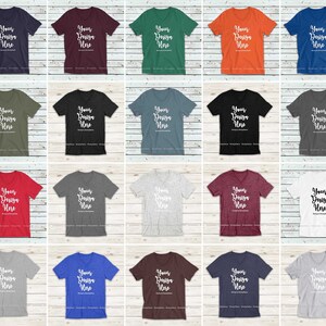 May include: A mockup of 20 different colored V-neck t-shirts with the text "Your Design Here" printed on each shirt. The shirts are arranged in a grid pattern on a white wood background.