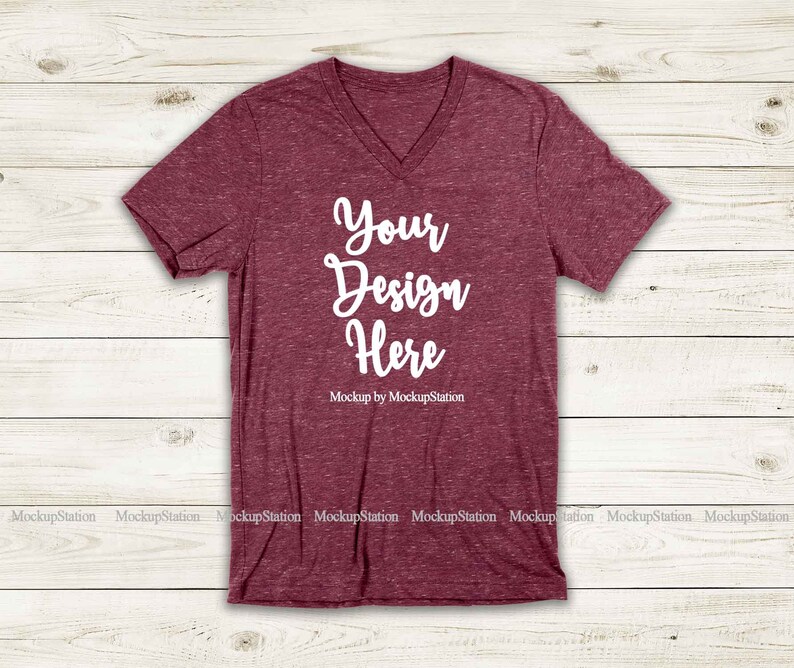May include: A maroon v-neck t-shirt with a heather texture. The shirt has the text "Your Design Here" printed on the front in white.
