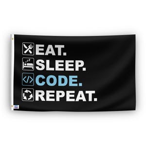 In a home setting, a flag with the saying "Eat Sleep Code Repeat" is mounted on a white wall by a side table.
