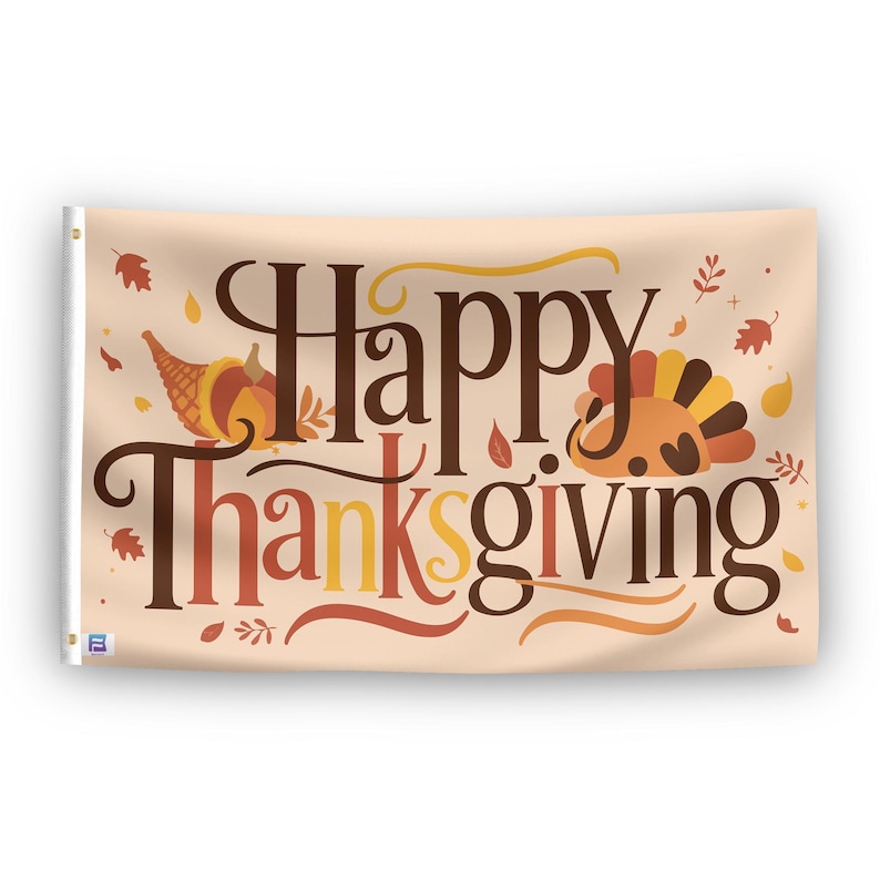 In a home setting, a flag with the saying "Happy Thanksgiving" is mounted on a white wall by a side table.
