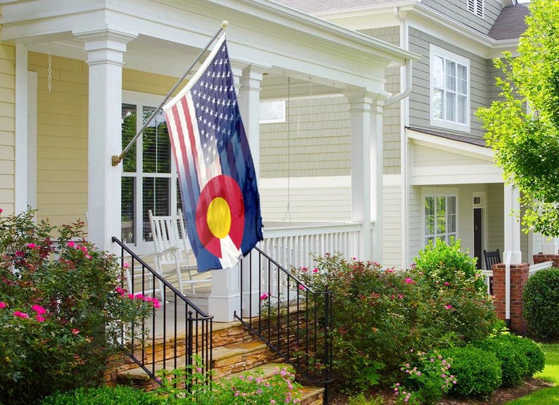 a living room with a guitar and a flag on the wall