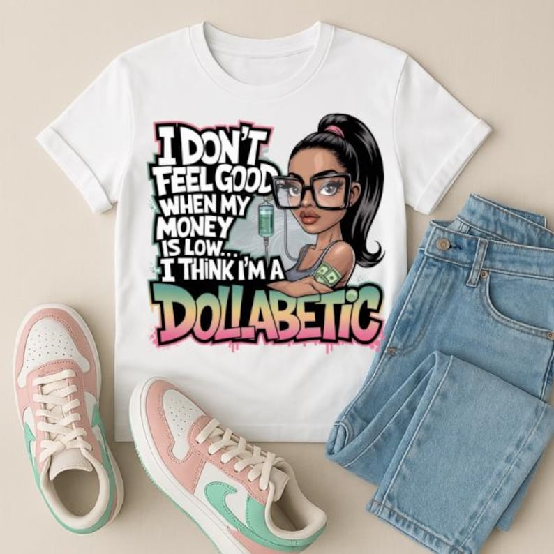 May include: White t-shirt with a cartoon illustration of a woman wearing glasses and a money-themed bandage. The text on the shirt reads "I don't feel good when my money is low... I think I'm a dollabetic."