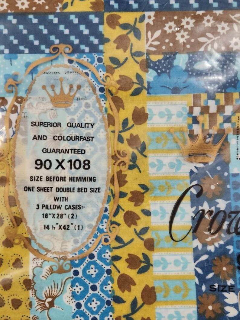 May include: A yellow and blue patchwork design bed sheet set with a label that says "Superior Quality and Colourfast Guaranteed 90 x 108 Size Before Hemming. One Sheet Double Bed Size with 3 Pillow Cases: 18" x 28" (2) 14 1/2" x 42" (1)"