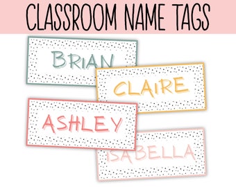 May include: Four colorful classroom name tags with black polka dots. The names are Brian, Claire, Ashley, and Isabella.
