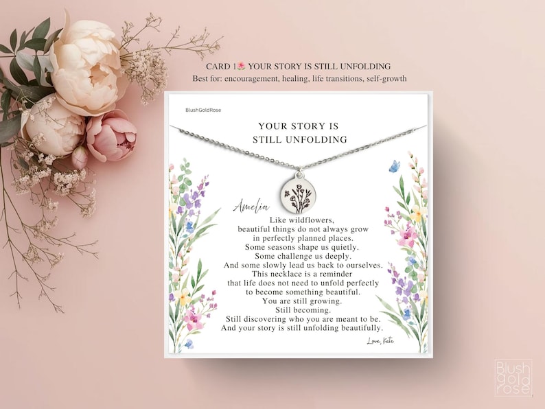 May include: A silver necklace with a round pendant featuring a floral design, presented on a card with the text "YOUR STORY IS STILL UNFOLDING". The card includes a message about growth and self-discovery, with floral illustrations.