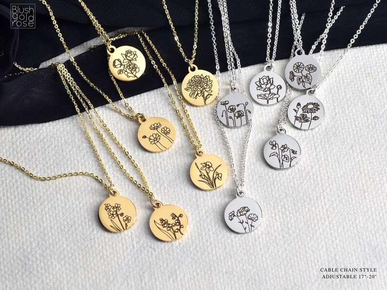 May include: A collection of gold and silver necklaces with round pendants, each engraved with a different floral design. The necklaces have delicate cable chains. The text "Blush Gold Rose" is in the upper left corner. The text "Cable Chain Style Adjustable 17"-20"" is in the lower right corner.