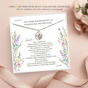 May include: A silver necklace with a round pendant featuring a floral design, presented on a card with the text "YOU WERE NEVER MEANT TO BLOOM LIKE ANYONE ELSE". The card has a floral watercolor design and the name "Amelia".