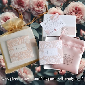 May include: Gift packaging with a floral background. The image shows a gold mesh bag, a pink satin pouch, and white boxes, all containing items. Cards with the text "for you" and "Beyond Grateful" are also visible. The brand name "Blush Gold Rose" is displayed.