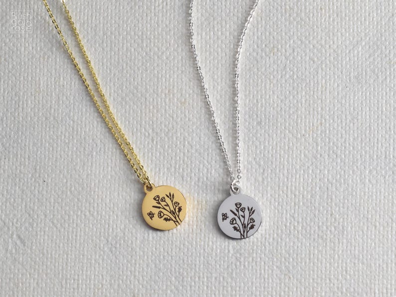 May include: Two delicate necklaces with floral pendant designs. One necklace is gold-toned, the other is silver-toned. Each pendant features a detailed botanical illustration. The chains are fine and elegant, suitable for everyday wear.