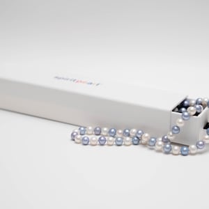 May include: A white box with the text "Aspire Pearl" on the top, with a strand of white and lavender pearls spilling out of the box.