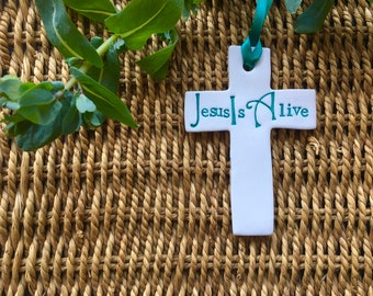 Jesus is alive: handmade cross decoration.