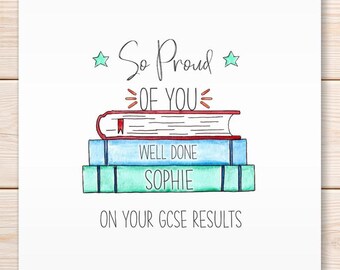 May include: A white card with a watercolor illustration of three stacked books. The top book is red, the middle is blue, and the bottom is green. Text reads "So Proud of You" and "Well Done Sophie On Your GCSE Results".