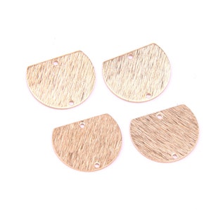 May include: Four gold-colored metal half-circle shapes with a textured surface and two holes each.