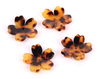 May include: Four brown and yellow plastic flower-shaped buttons with a hole in the center.