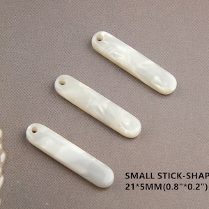 May include: Three white, stick-shaped,  pearlescent plastic charms with a hole at the top.  SMALL STICK-SHAPED 21*5MM(0.8"*0.2")