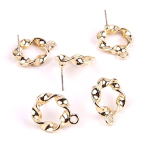May include: Four gold-toned earring findings with a twisted, circular design. Each finding has a post and a loop.