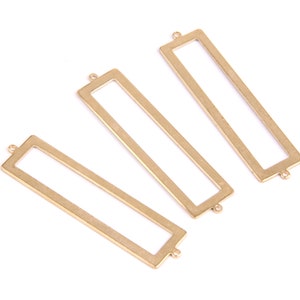 May include: Three gold-colored metal rectangular frames with open centers. The frames are different sizes and have rounded corners.
