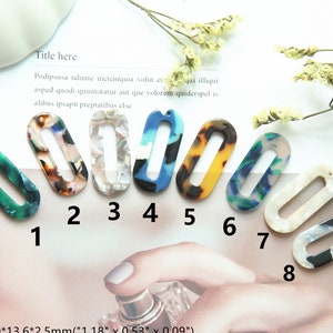 May include: Eight oval-shaped plastic earrings with different colorful patterns. The earrings are approximately 3 cm long and 1.3 cm wide. The earrings have a hole at the top for attaching a hook or other earring finding.