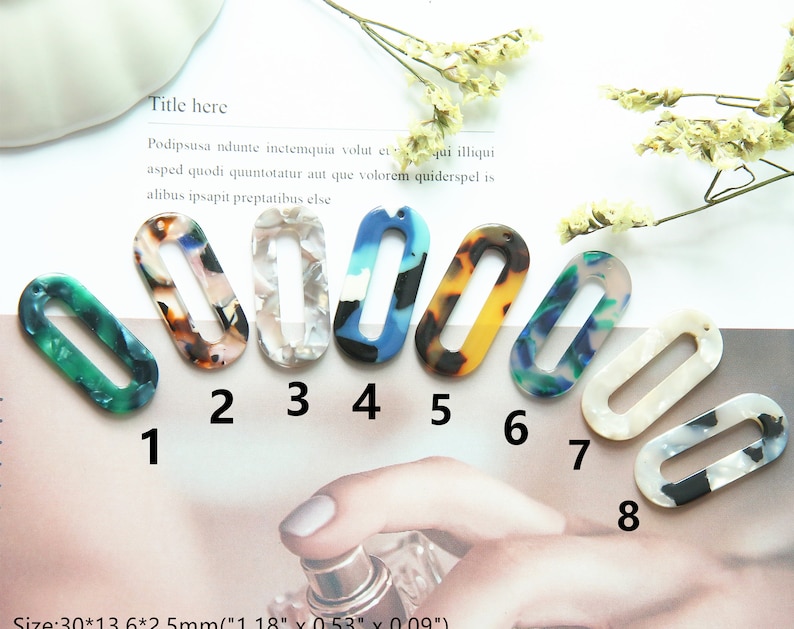 May include: Eight oval-shaped plastic earrings with different colorful patterns. The earrings are approximately 3 cm long and 1.3 cm wide. The earrings have a hole at the top for attaching a hook or other earring finding.