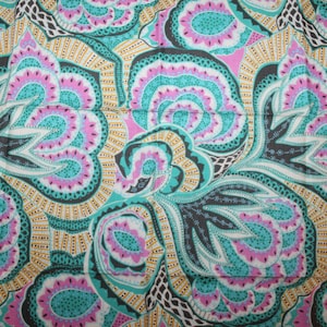 May include: A teal, pink, and black paisley patterned fabric with a repeating design. The fabric has a vintage feel and would be great for crafting projects.
