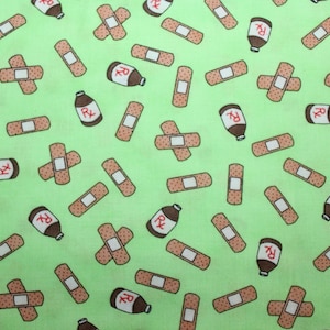 May include: A light green fabric with a repeating pattern of brown bandages and brown medicine bottles with the letters "Rx" on them. The bandages are in various orientations, some crossed, and the bottles are upright and upside down.