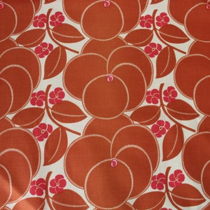 May include: A seamless fabric pattern with a repeating design of stylized orange fruit and leaves in shades of orange and pink on a white background.