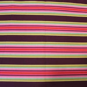 May include: A fabric with horizontal stripes in shades of purple, pink, red, green, and yellow.