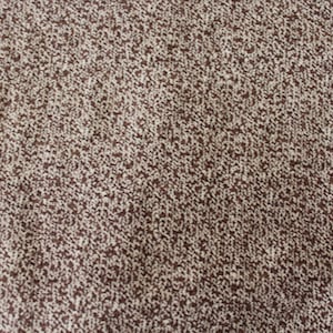May include: Close-up of a brown and white speckled fabric with a subtle texture.