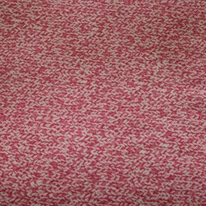 May include: Close-up of a textured fabric with a repeating pattern. The fabric has a red and off-white color scheme, with a woven or knitted appearance. The pattern is a series of diagonal lines.