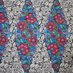 May include: Black fabric with a repeating pattern of colorful flowers. The flowers are red, pink, blue, green, and yellow. The background is black with white accents.
