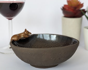Foxes sleep anywhere bowl. Black bowl with fox on sleeping on rim.