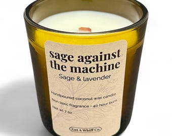 May include: A sage and lavender scented candle in a clear glass jar. The label reads "Sage against the machine." The candle is handpoured with coconut wax and has a 40-hour burn time. Net weight is 7 oz.