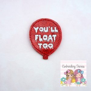 May include: A red glittery balloon-shaped patch with the text "YOU'LL FLOAT TOO" in white, dripping font. The patch has a stitched border and a small stem. The image includes a logo with two cartoon girls.